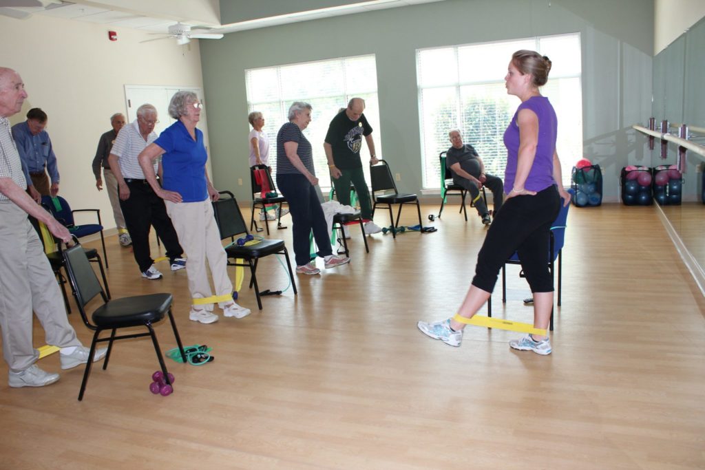 Residents and instructor in fitness studio