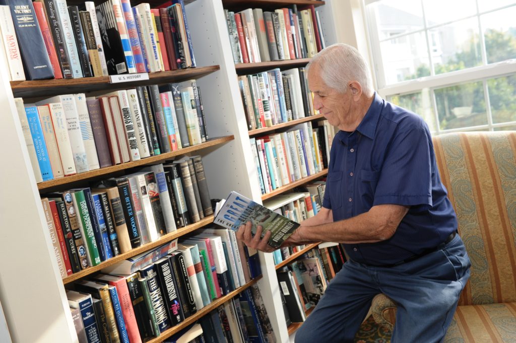 Male resident looking at books in the library