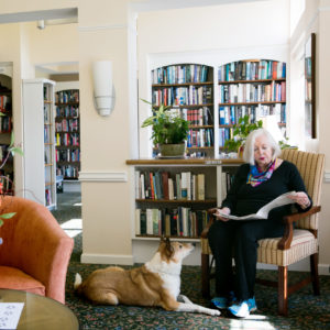 woman and dog in library
