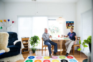 Couple drinking coffee at a table in their cottage