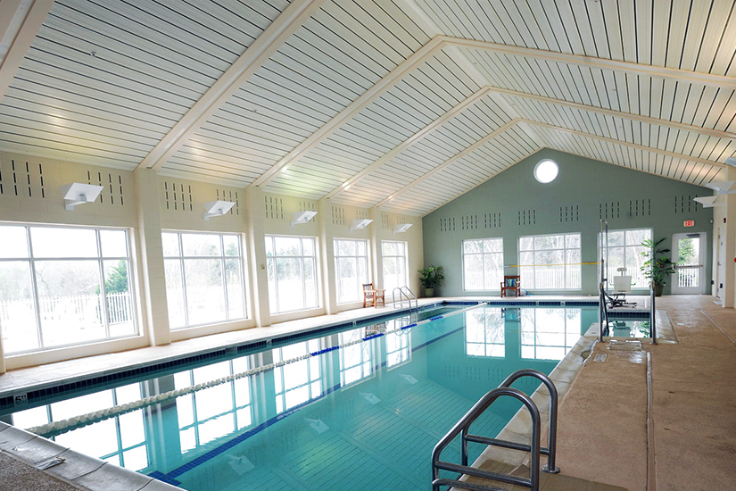 View of indoor pool with light streaming through windows