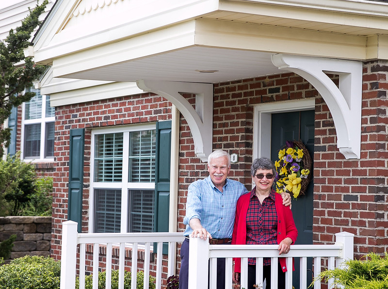 Resident couple on their cottage porch