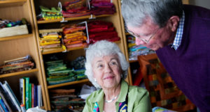 man and woman resident in quilt room