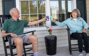 couple cheers on porch