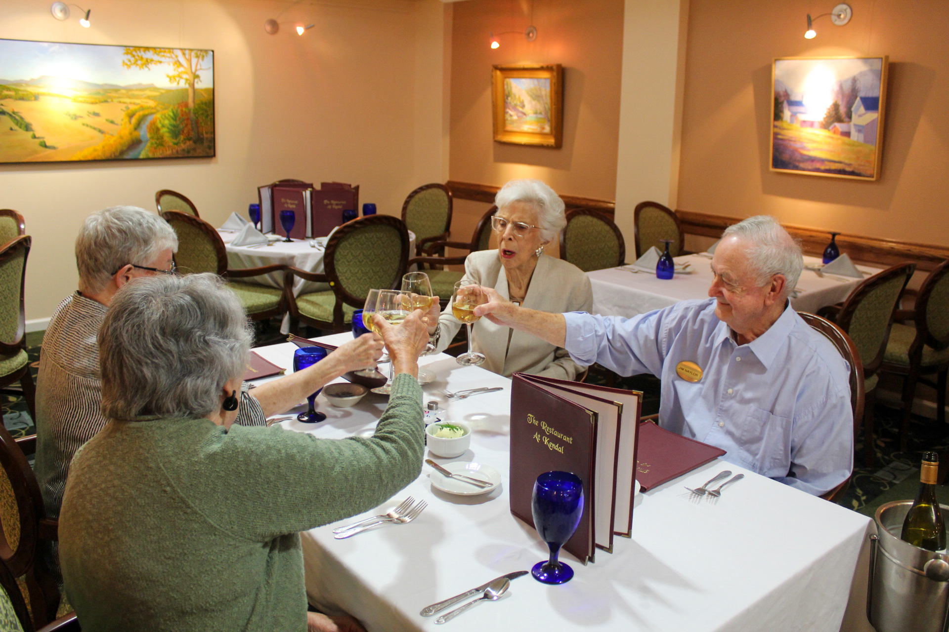 Photo of four residents dining in the restaurant.