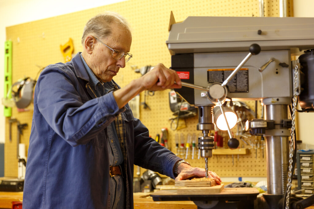 resident works in Kendal woodshop.
