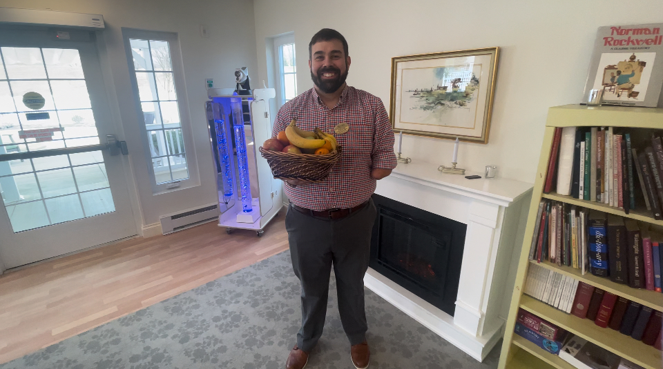 Photo of Steven Veiga holding a fruit basket.