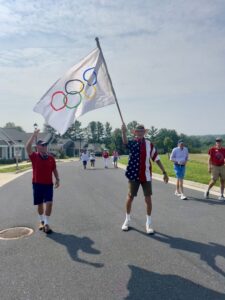 Kendal staff and residents carry the Olympic flag.