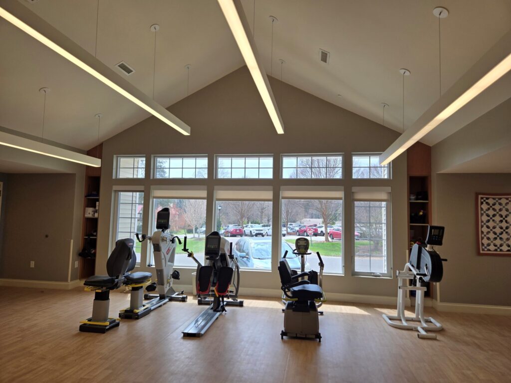 Inside the therapy room. Exercise machines in front of window.